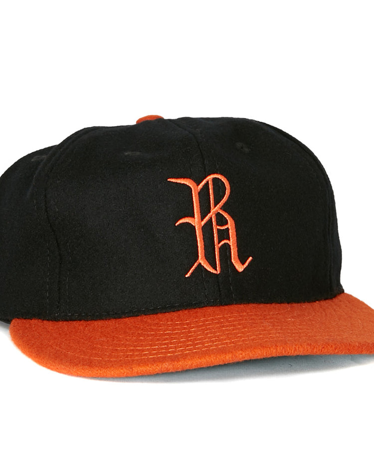 The EFF Richmond Virginians 1955 Vintage Ballcap is a black wool baseball cap featuring an orange brim and an orange embroidered R logo on the front, inspired by the classic 1955 design.