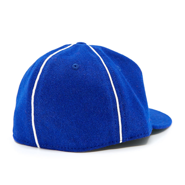 The EFF Seattle Rainiers 1941 Vintage Ballcap features blue fabric with white piping, shown from the back at an angle against a white background.