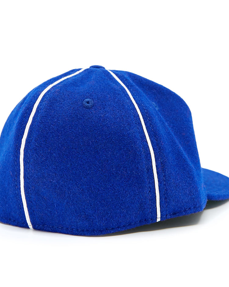 The EFF Seattle Rainiers 1941 Vintage Ballcap features blue fabric with white piping, shown from the back at an angle against a white background.