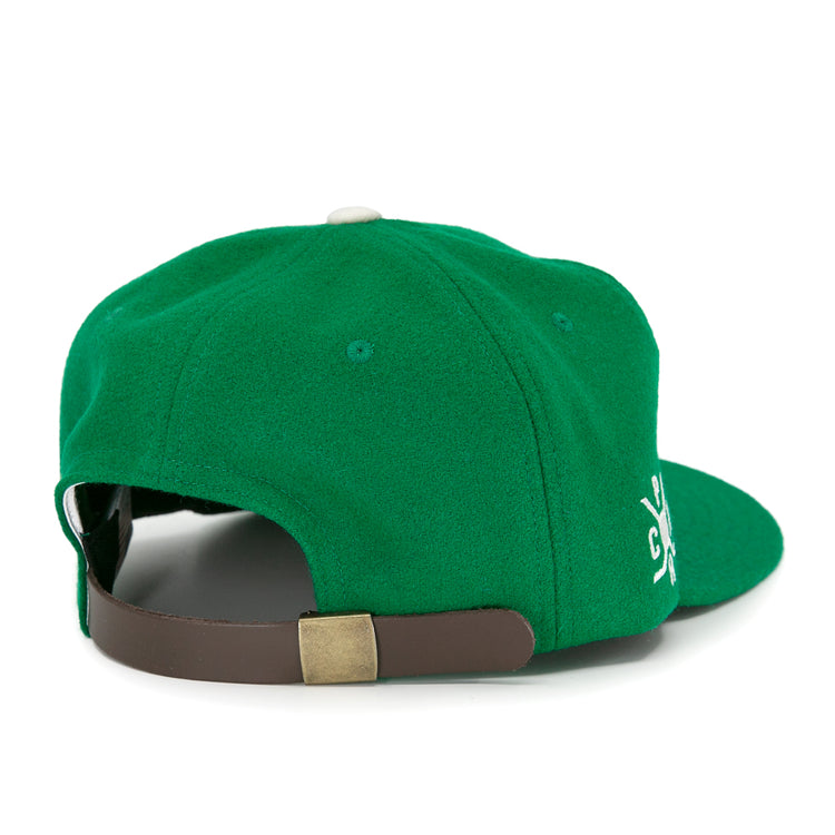 The EFF Seattle Metropolitans 1917 Vintage Ballcap is a green hat viewed from the back, showing an adjustable brown leather strap with brass buckle and a partially visible white embroidered side design.