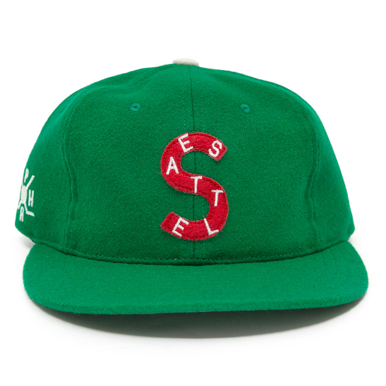 The EFF Seattle Metropolitans 1917 Vintage Ballcap is a green wool cap featuring a large red S, small white SEATTLE lettering vertically on the front, and white side embroidery, inspired by vintage Pacific Coast Hockey Association hats.