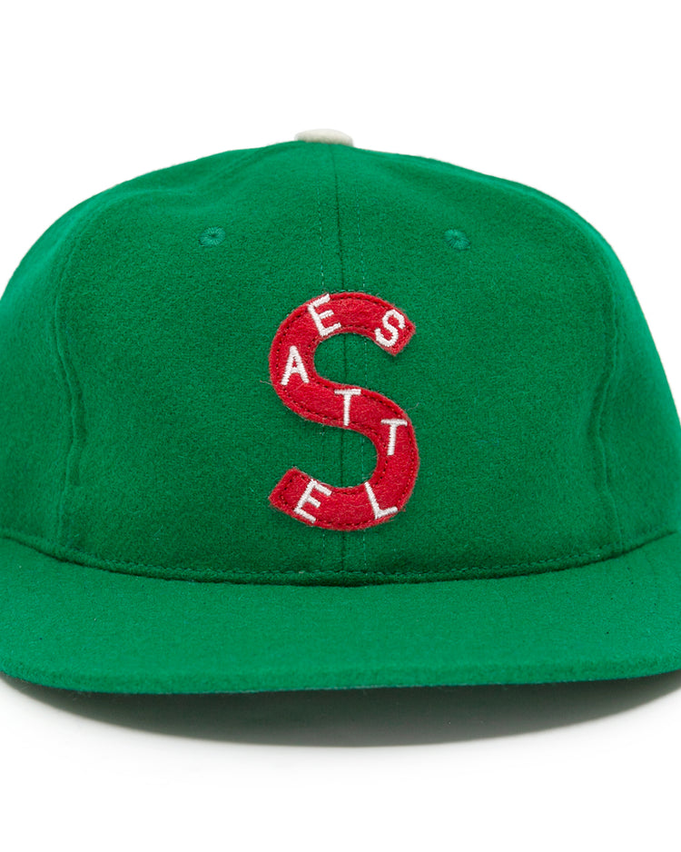 The EFF Seattle Metropolitans 1917 Vintage Ballcap is a green wool cap featuring a large red S, small white SEATTLE lettering vertically on the front, and white side embroidery, inspired by vintage Pacific Coast Hockey Association hats.