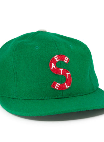 The EFF Seattle Metropolitans 1917 Vintage Ballcap is a green wool hat with a red and white S logo made of the letters A, E, S, T, E, L. White-embroidered letters A, P, H, and A appear on the side—vintage Pacific Coast Hockey Association style.