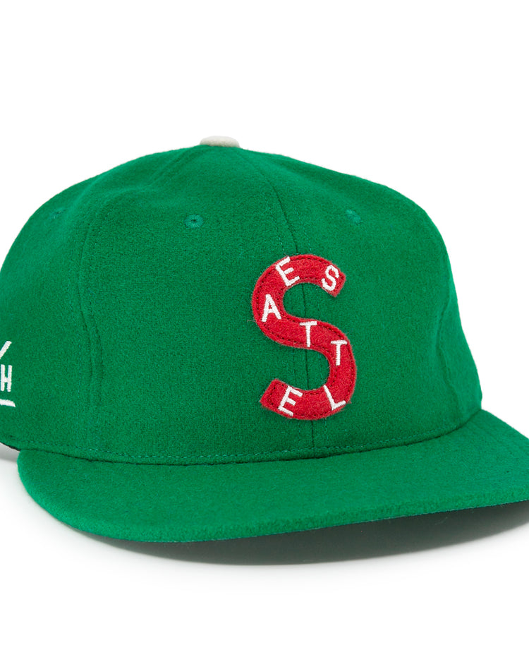 The EFF Seattle Metropolitans 1917 Vintage Ballcap is a green wool hat with a red and white S logo made of the letters A, E, S, T, E, L. White-embroidered letters A, P, H, and A appear on the side—vintage Pacific Coast Hockey Association style.