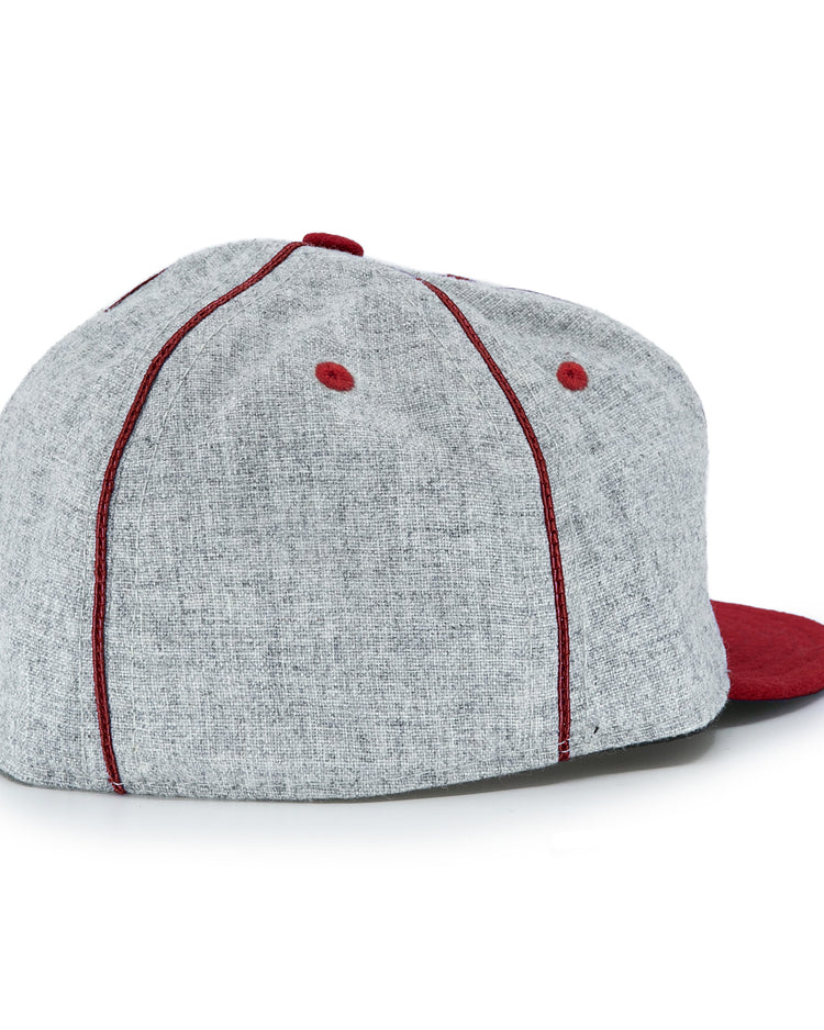 The EFF San Francisco Post Office 1939 Vintage Ballcap is shown from the back and slightly to the side on a white background, featuring gray fabric with red stitched seams, red ventilation eyelets, and a red brim.