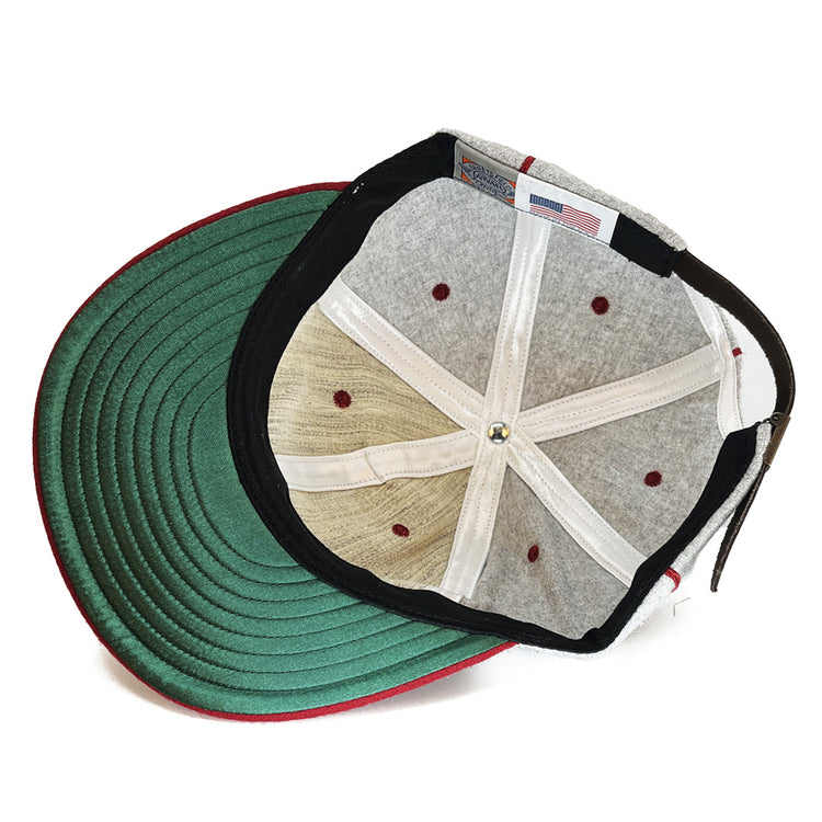The image shows the inside of the EFF San Francisco Post Office 1939 Vintage Ballcap, featuring a green brim, grey top panels, white sweatband, red stitching, and an American flag tag inside.