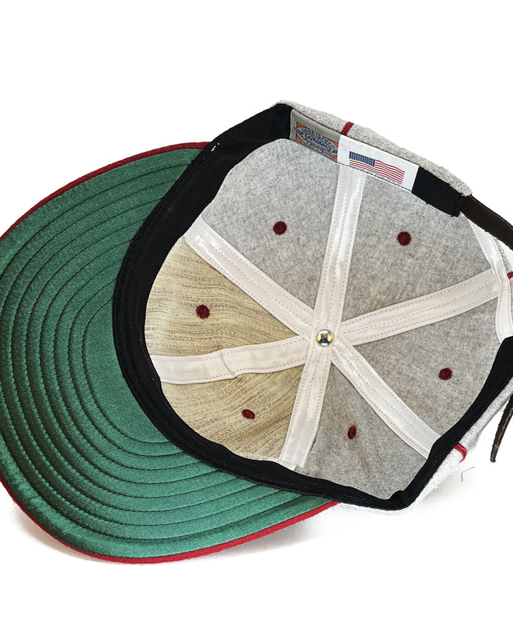 The image shows the inside of the EFF San Francisco Post Office 1939 Vintage Ballcap, featuring a green brim, grey top panels, white sweatband, red stitching, and an American flag tag inside.