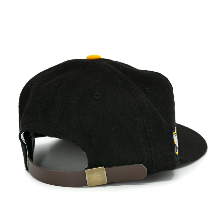 The EFF San Francisco Seals 1963 Vintage Ballcap is black wool, shown from the back with a brown adjustable strap, gold buckle, yellow top button, and classic team style.