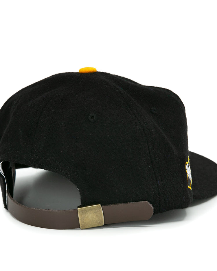 The EFF San Francisco Seals 1963 Vintage Ballcap is black wool, shown from the back with a brown adjustable strap, gold buckle, yellow top button, and classic team style.