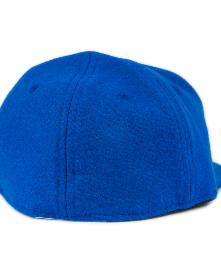 The Southern Methodist University 1962 Vintage Ballcap by EFF is a blue wool baseball cap shown from the back, featuring visible stitching and no logo or adjustment strap for a classic vintage look.