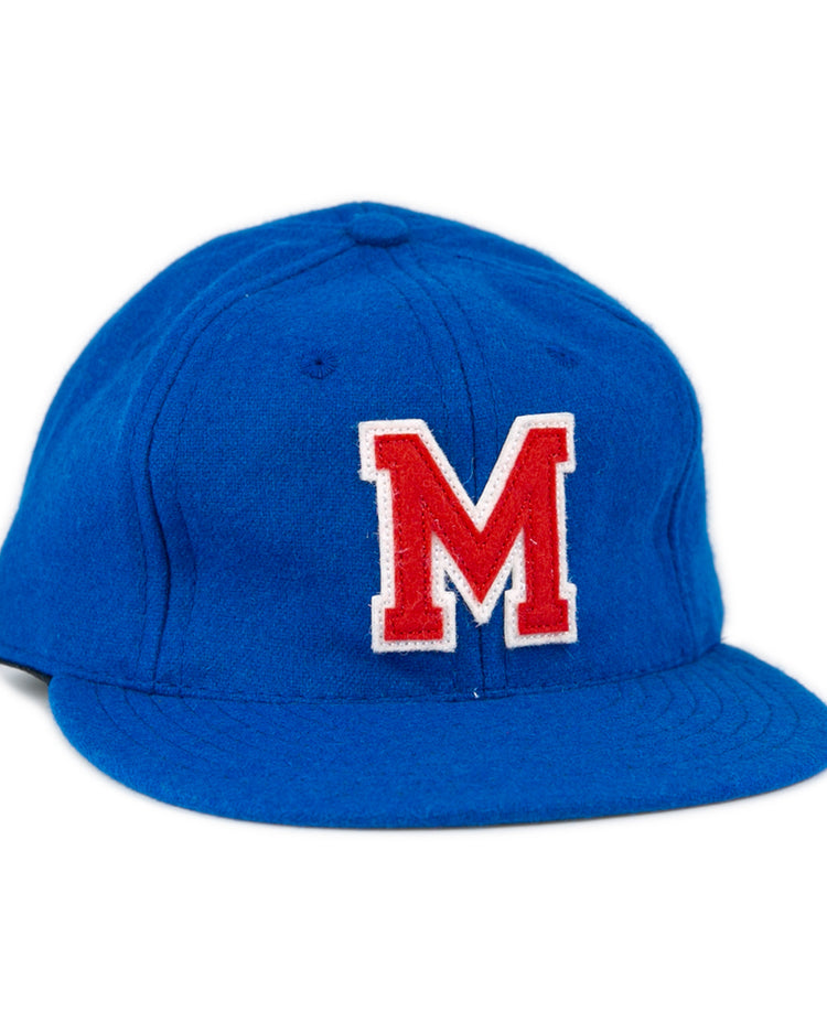 The EFF Southern Methodist University 1962 Vintage Ballcap is a blue wool cap featuring a large red M outlined in white on the front, reminiscent of classic SMU style, displayed against a plain white background.
