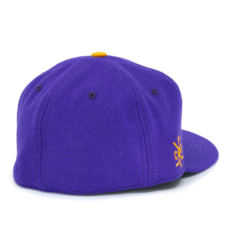 The EFF Spokane Canaries 1917 Vintage Ballcap is a purple wool cap with dark purple stitched eyelets and panels, a yellow top button, partial yellow side embroidery, and an adjustable leather strap for the perfect fit.