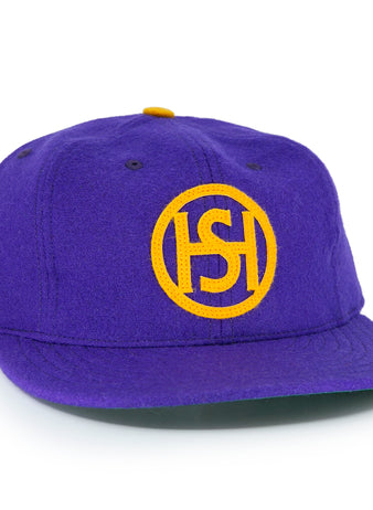 The EFF Spokane Canaries 1917 Vintage Ballcap is a purple wool cap with a yellow embroidered circular ISH logo, Pacific Coast Hockey Association-inspired yellow side lettering, and an adjustable leather strap for comfort.