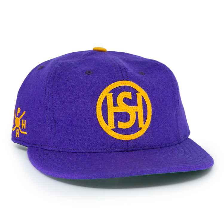 The EFF Spokane Canaries 1917 Vintage Ballcap is a purple wool cap with a yellow embroidered circular ISH logo, Pacific Coast Hockey Association-inspired yellow side lettering, and an adjustable leather strap for comfort.