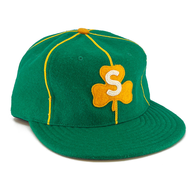The EFF St. Patrick Shamrocks 1925 Vintage Ballcap is made in the USA with green wool, yellow piping, a yellow top button, and a front yellow clover patch with a white S, capturing the classic vintage style.