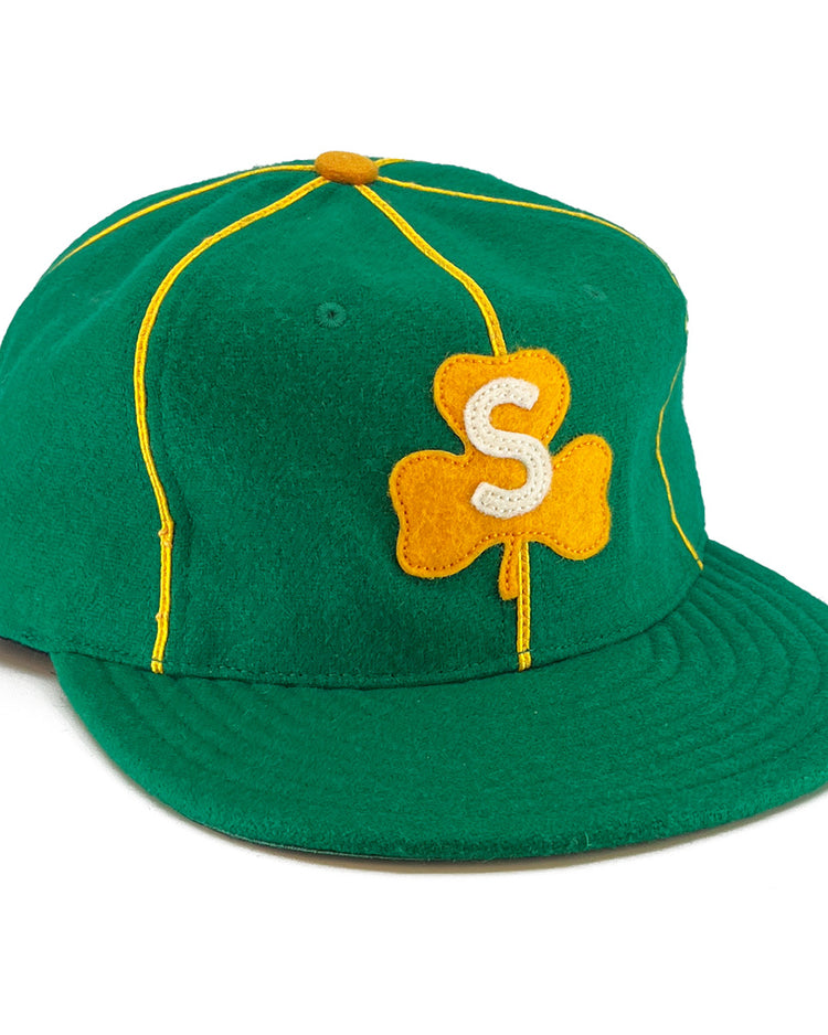 The EFF St. Patrick Shamrocks 1925 Vintage Ballcap is made in the USA with green wool, yellow piping, a yellow top button, and a front yellow clover patch with a white S, capturing the classic vintage style.