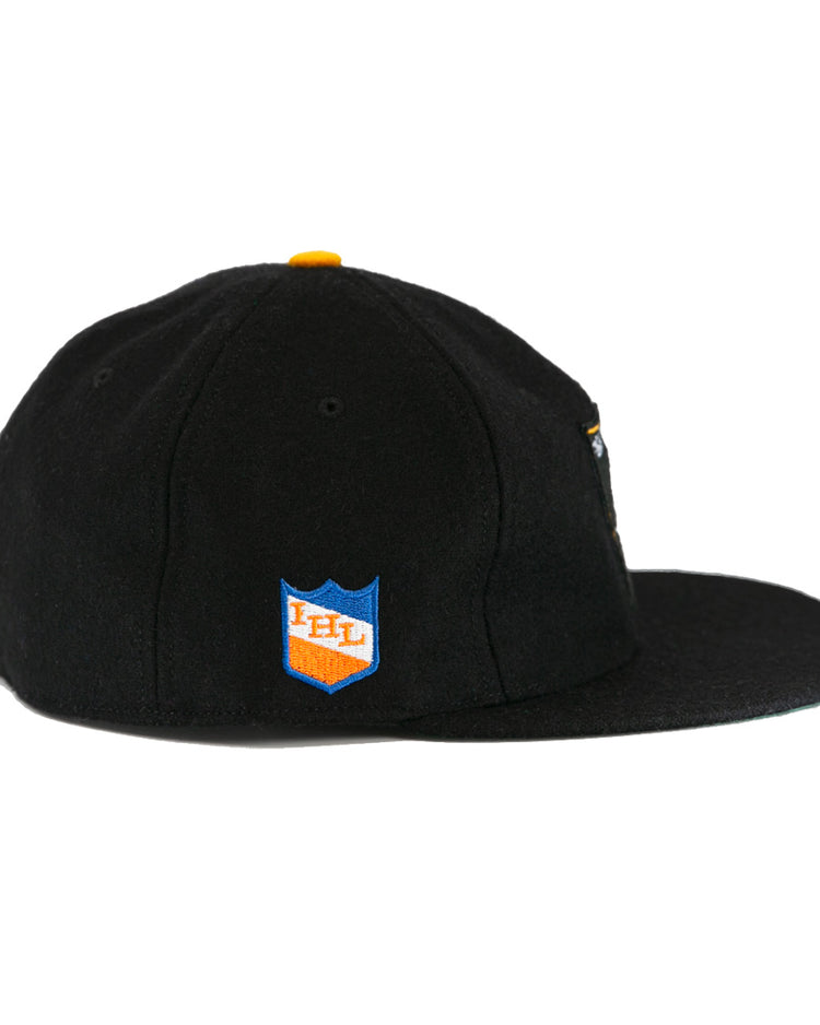 The EFF St. Paul Fighting Saints 1961 Vintage Ballcap is a black wool cap with a flat brim, yellow top button, and a blue and orange shield patch on the side featuring IHL in white.