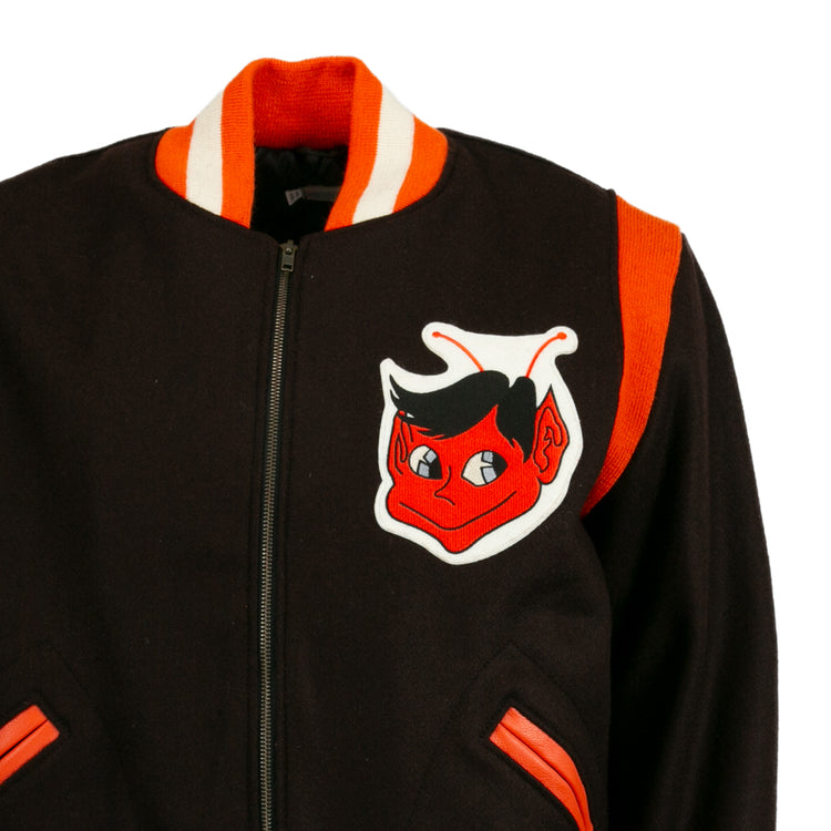 The EFF St. Louis Browns 1952 Authentic Jacket is a vintage wool baseball jacket with orange and white trim, a red cartoon devil patch on the chest, orange shoulder stripe, zip front, and orange-trimmed pockets.