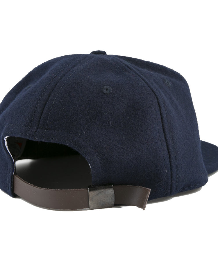 The EFF Tacoma Twins 1974 Vintage Ballcap in navy blue is shown from the back, highlighting its brown adjustable leather strap with metal clasp inspired by classic Pacific Coast League baseball cap designs.