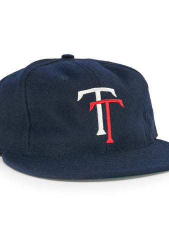 The EFF Tacoma Twins 1974 Vintage Ballcap is a navy blue cap featuring a white and red interlocking T logo on the front, inspired by the Pacific Coast League.