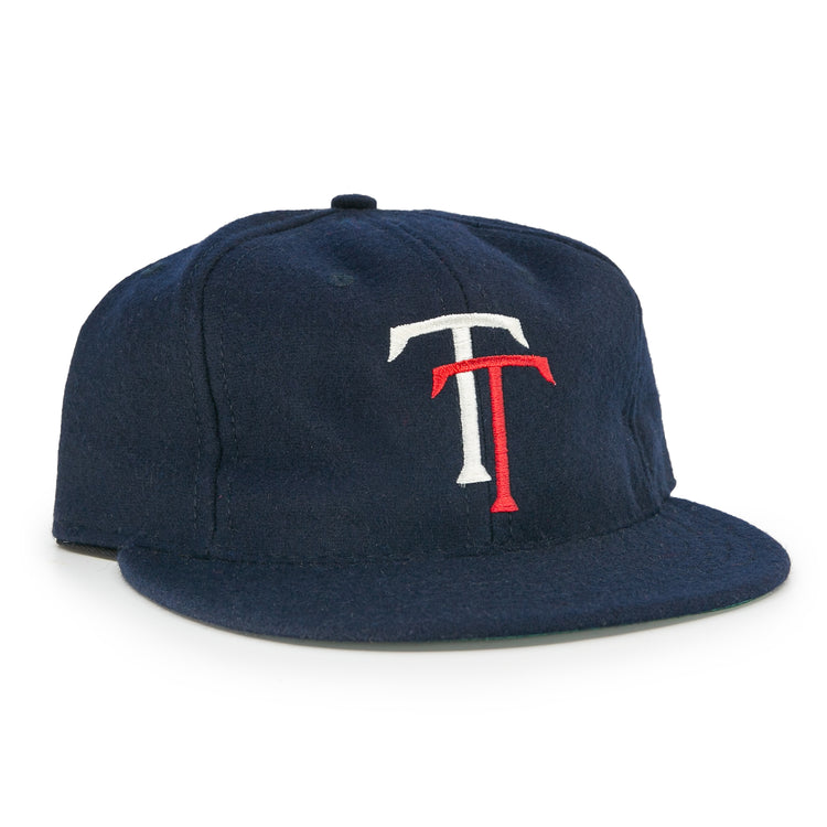 The EFF Tacoma Twins 1974 Vintage Ballcap is a navy blue cap featuring a white and red interlocking T logo on the front, inspired by the Pacific Coast League.