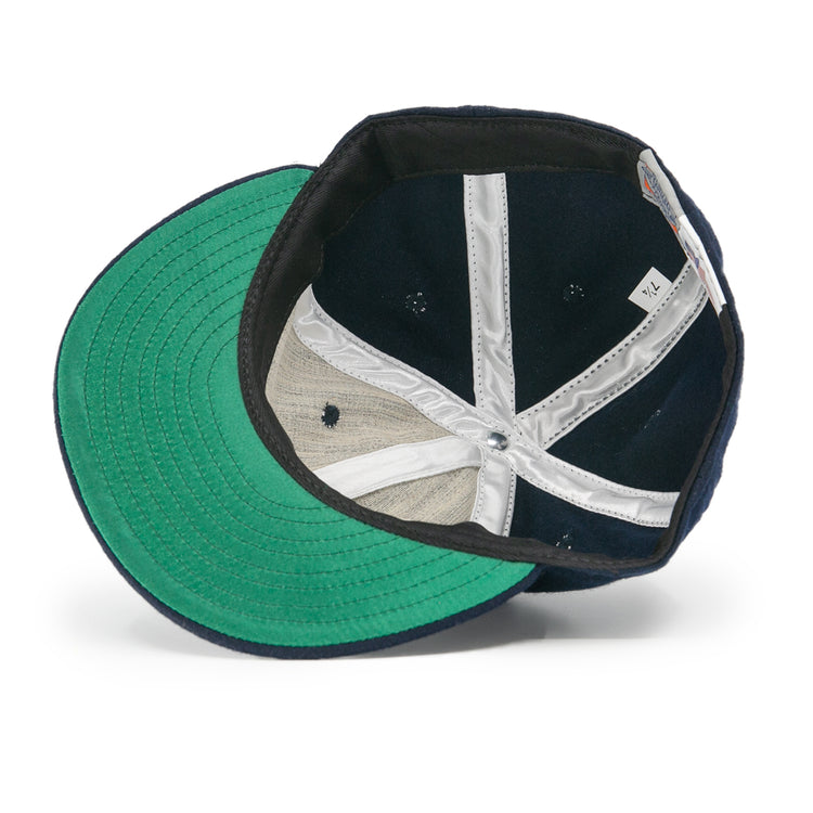 The image shows the interior of an EFF Tacoma Twins 1974 Vintage Ballcap in navy with a green brim, white sweatband, exposed stitching, and a visible size tag marked 7 1/4.