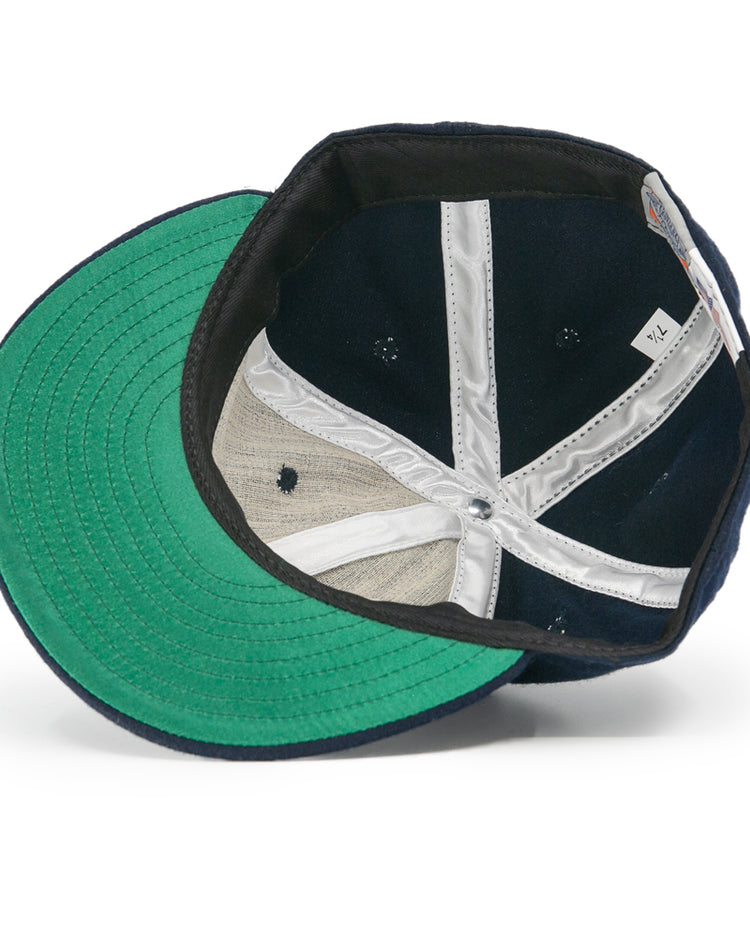 The image shows the interior of an EFF Tacoma Twins 1974 Vintage Ballcap in navy with a green brim, white sweatband, exposed stitching, and a visible size tag marked 7 1/4.