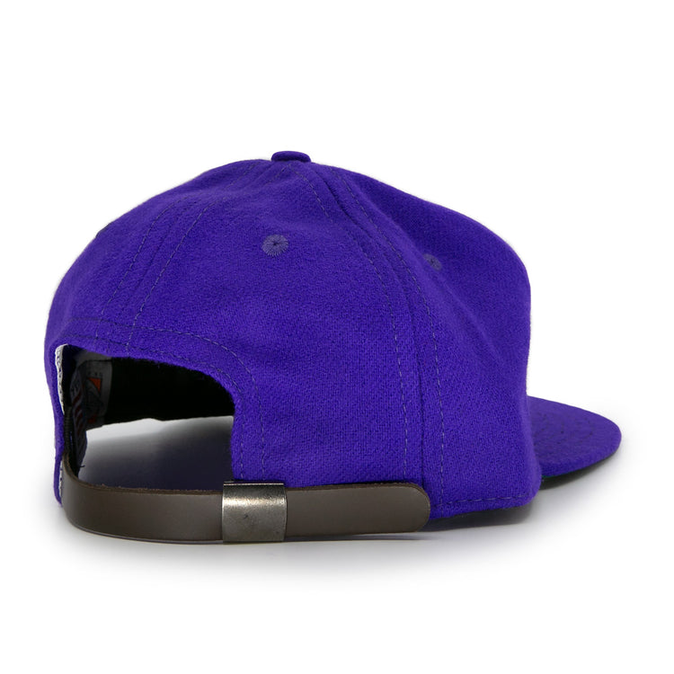 The Club Teléfonos 1943 Vintage Ballcap by Ebbets Field Flannels is a purple wool hat shown from the back, featuring a black adjustable strap with a metal buckle.