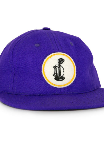 The Ebbets Field Flannels Club Teléfonos 1943 Vintage Ballcap is purple and features a front circular patch with a yellow-outlined black rotary phone design.