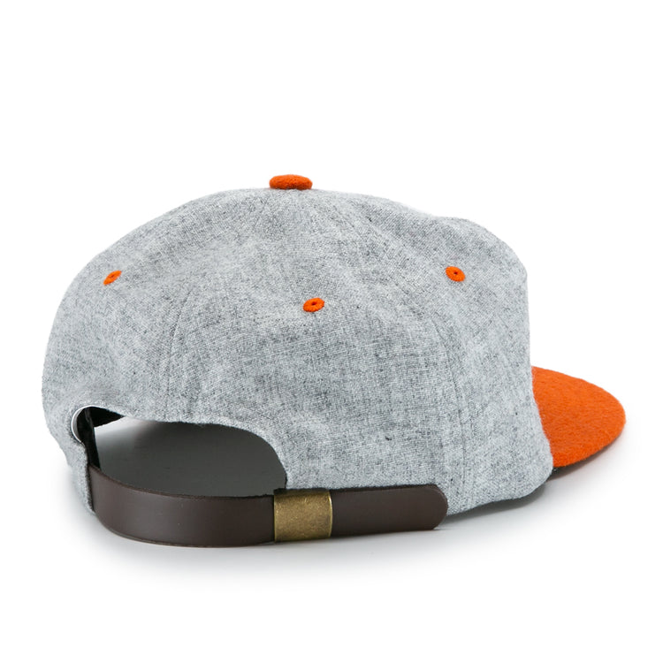 The University of Tennessee 1962 Vintage Ballcap by Ebbets Field Flannels is shown from the back, featuring gray fabric, orange accents, a brown adjustable strap with brass buckle, and an orange bill—a classic Volunteers tribute.
