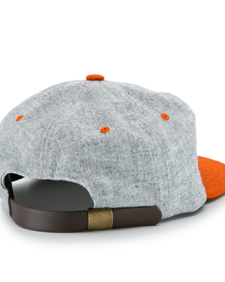 The University of Tennessee 1962 Vintage Ballcap by Ebbets Field Flannels is shown from the back, featuring gray fabric, orange accents, a brown adjustable strap with brass buckle, and an orange bill—a classic Volunteers tribute.