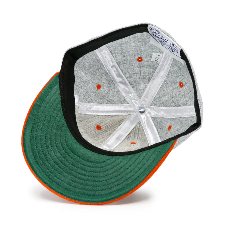 The Ebbets Field Flannels University of Tennessee 1962 Vintage Ballcap features a green underbrim with orange trim, orange eyelets, white support ribbons, and a blue-and-white brand label, capturing its classic retro style.