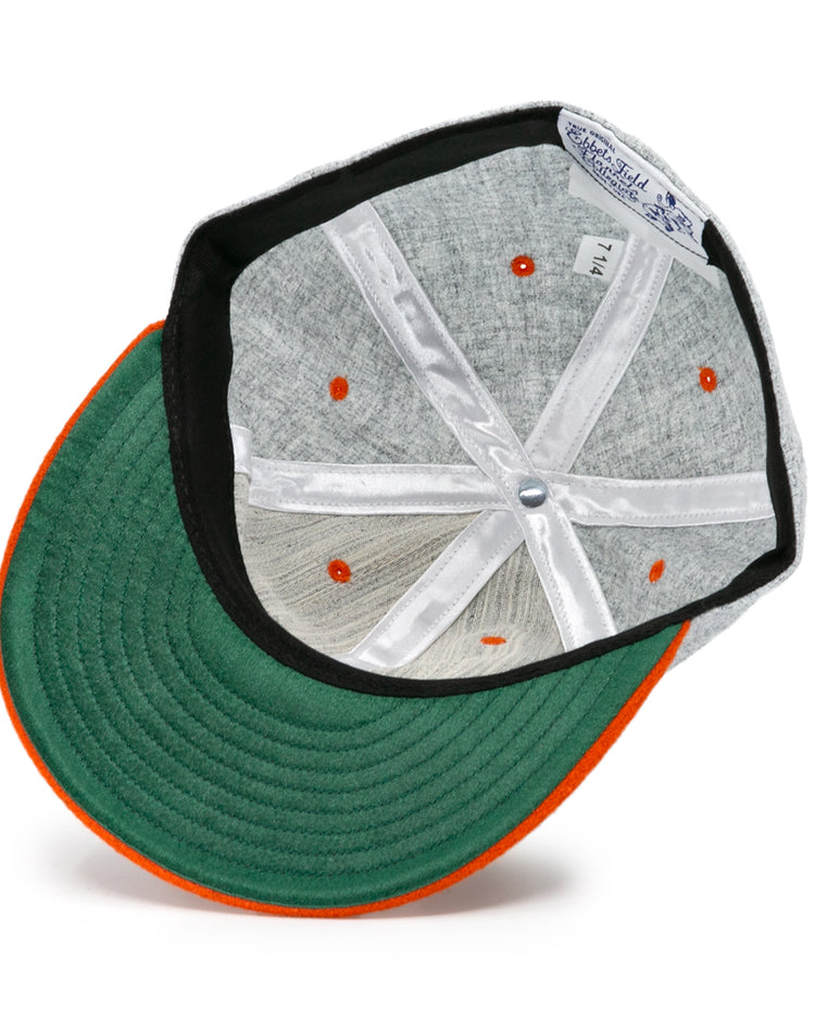 The Ebbets Field Flannels University of Tennessee 1962 Vintage Ballcap features a green underbrim with orange trim, orange eyelets, white support ribbons, and a blue-and-white brand label, capturing its classic retro style.