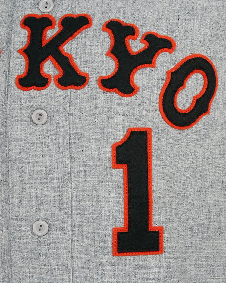 A close-up of the EFF Tokyo Kyojin (Giants) 1961 Road Jerseys gray fabric shows black and red TOKYO lettering, a large black number 1 below, and three buttons, capturing details of this classic Japanese League replica.