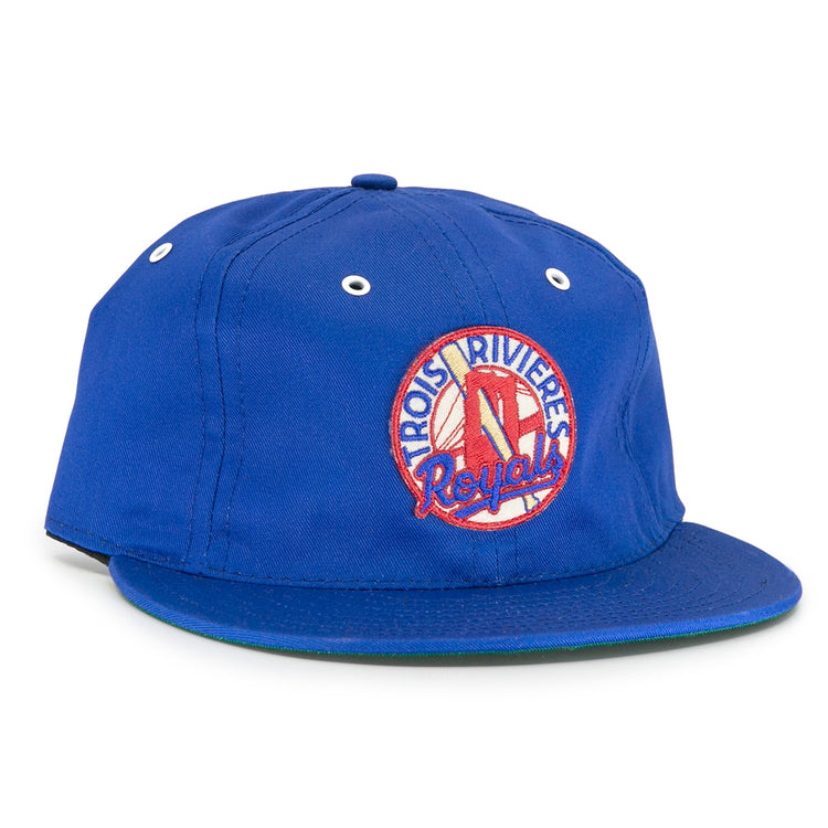 The EFF Trois Rivières Royals Cotton Twill Ballcap features a blue design, front round patch with bat and glove, white eyelets, green brim underside, and celebrates the Canadian-American League.