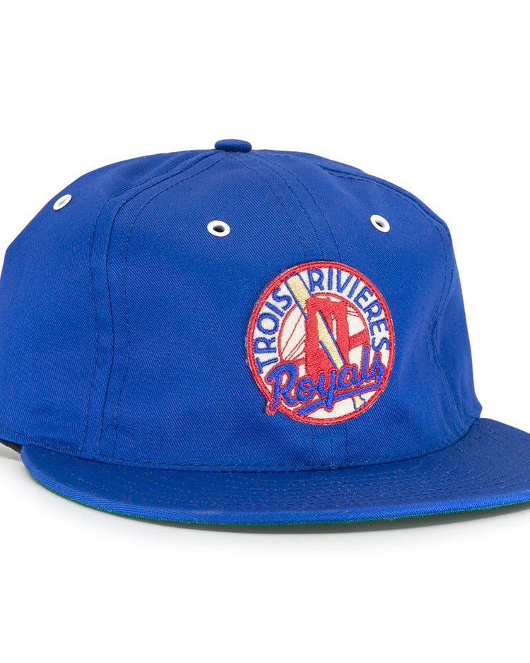 The EFF Trois Rivières Royals Cotton Twill Ballcap features a blue design, front round patch with bat and glove, white eyelets, green brim underside, and celebrates the Canadian-American League.