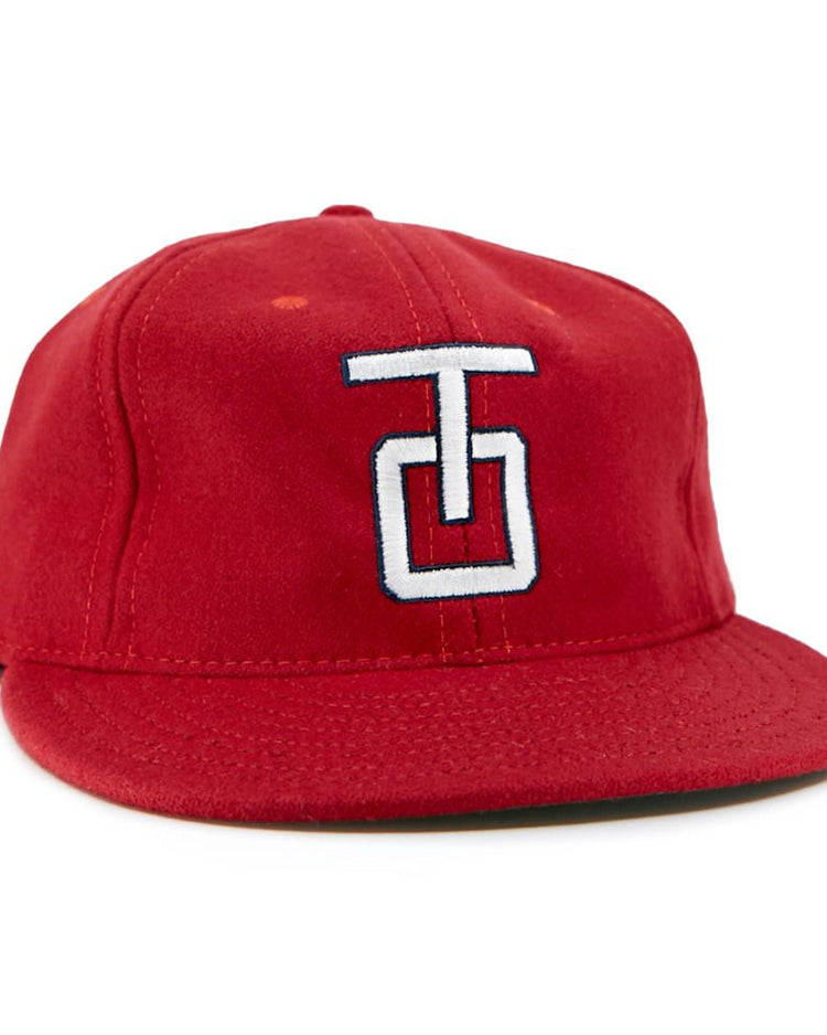 The EFF Tulsa Oilers 1966 Vintage Ballcap is a red wool cap with a flat brim and a white and blue embroidered TG logo on the front.
