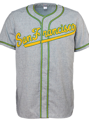The EFF University of San Francisco 1947 Road Jersey is a gray button-up with green and yellow trim, featuring San Francisco in cursive across the chest, inspired by the authentic 1947 baseball jersey.