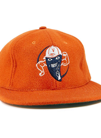 The EFF Victoria Mussels 1979 Vintage Ballcap is an orange cap with an embroidered smiling character—blue face mask, flexed arms, and a white cap featuring a red V on the front.