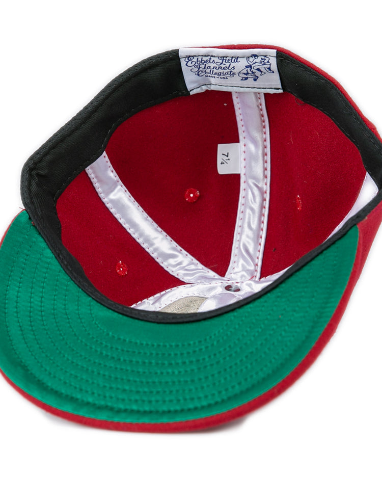 A red Virginia Tech 1963 Vintage Ballcap by EFF, turned inside out to show a green brim, white stitching, and an EFF label. The inner size tag reads 7 1/4. Inspired by the officially licensed Collegiate Vault.