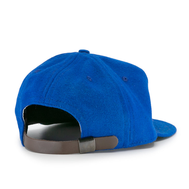 The EFF Wichita Falls Spudders 1956 Vintage Ballcap in royal blue is shown from the back, highlighting its dark brown adjustable strap and metal clasp.