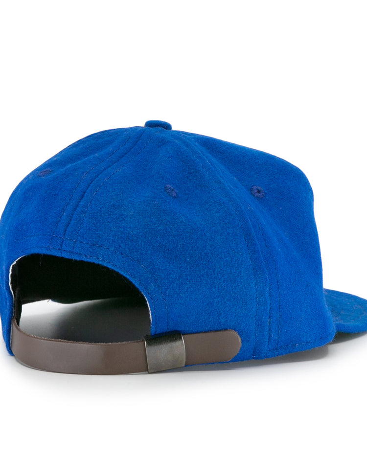 The EFF Wichita Falls Spudders 1956 Vintage Ballcap in royal blue is shown from the back, highlighting its dark brown adjustable strap and metal clasp.