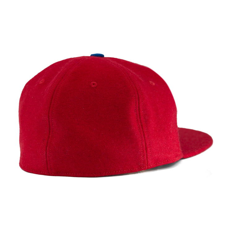The EFF Wembley Lions 1957 Vintage Ballcap features bright red hand-sewn wool, a rounded crown, blue top button, and no visible strap, capturing the classic look of British National Hockey League styles from the back view.