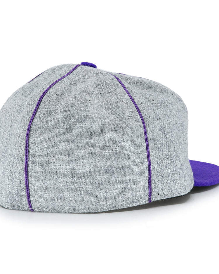 The EFF University of Washington 1938 Vintage Ballcap features gray fabric, purple stitching, and a purple brim. Shown from the back at an angle, its perfect for fans wanting a classic UW look.