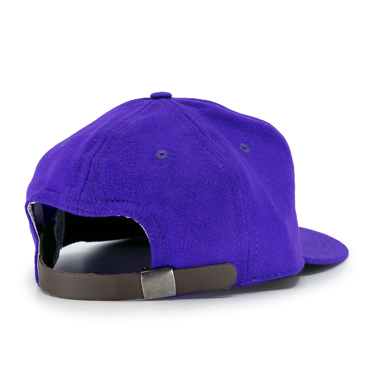 The EFF University of Washington 1950 Vintage Ballcap in purple is shown from the back, featuring a brown adjustable strap with a metal clasp. This authentic cap is crafted from genuine wool.