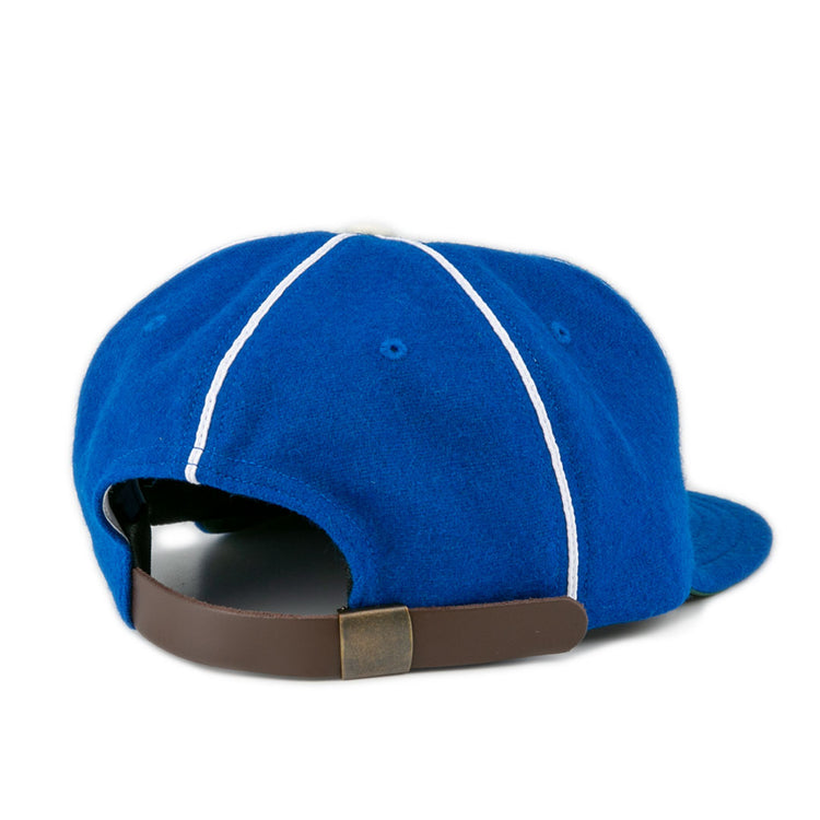 The EFF Wyoming State Penitentiary 1911 Vintage Ballcap in blue features white stitching, a curved brim, and an adjustable brown leather strap with brass buckle. Classic style, made in the USA.