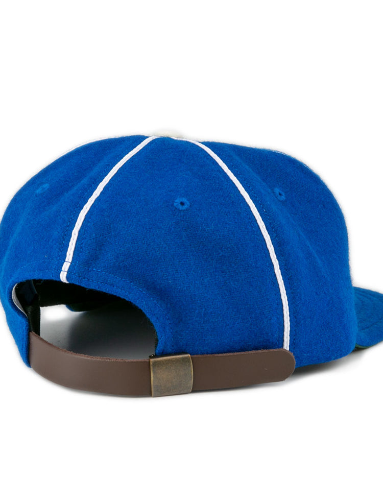 The EFF Wyoming State Penitentiary 1911 Vintage Ballcap in blue features white stitching, a curved brim, and an adjustable brown leather strap with brass buckle. Classic style, made in the USA.