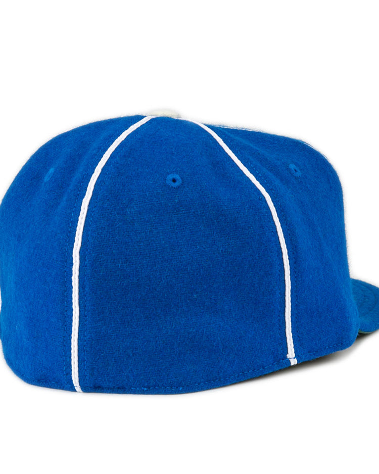 The EFF Wyoming State Penitentiary 1911 Vintage Ballcap is a royal blue cap with white vertical stitching, a flat brim on the right side, and is proudly made in the USA.