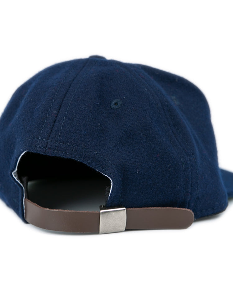 The West Virginia University 1966 Vintage Ballcap by Ebbets Field Flannels is a navy blue cap with a brown adjustable strap and silver buckle, capturing the classic style of the ’66 Mountaineers.