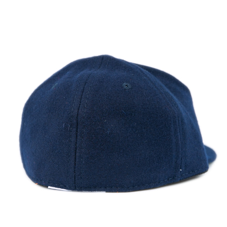 The Ebbets Field Flannels West Virginia University 1966 Vintage Ballcap features navy blue wool, visible stitching, and a gently curved shape, capturing the classic look of the original Mountaineers cap from 1966.